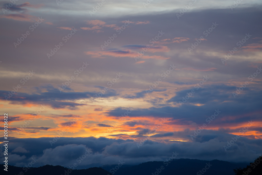 Sky and cloud at sunset with dark and vibrant light at  dusk