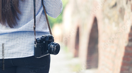 A yong girl with a vintagea camera photo