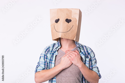 Love, emotion and relationship concept - Man with cardboard box on his head with enamored face.