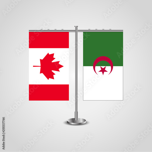 Table stand with flags of Canada and Algeria.Two flag. Flag pole. Symbolizing the cooperation between the two countries. Table flags