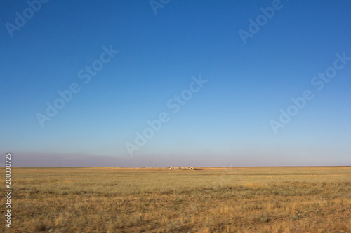 Desert dry steppe in summer and the structure in the middle of the field.