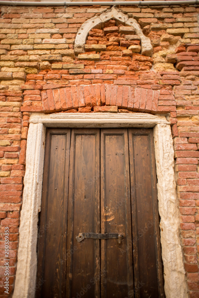 Door in Red Brick Wall in Venice. Italy.