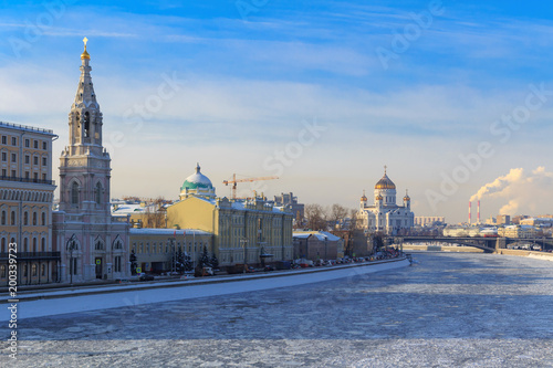 Frozen Moskva river. View of Sofiyskaya embankment in sunny winter day