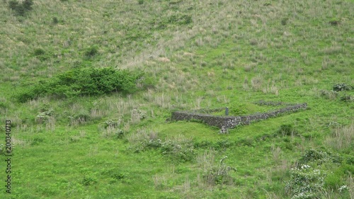 Traditional grave in Jeju Island, Korea. In Jeju, people made a grave at the center of square shape stone wall. photo