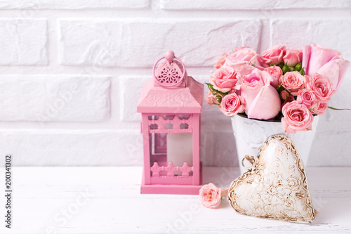 Pink roses flowers  in white pot, decorative heart and pink lantern