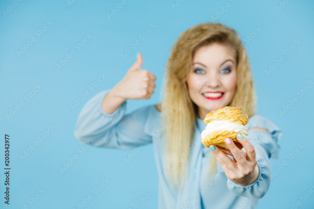 Funny woman holds cream puff cake Funny woman holds cream puff cake