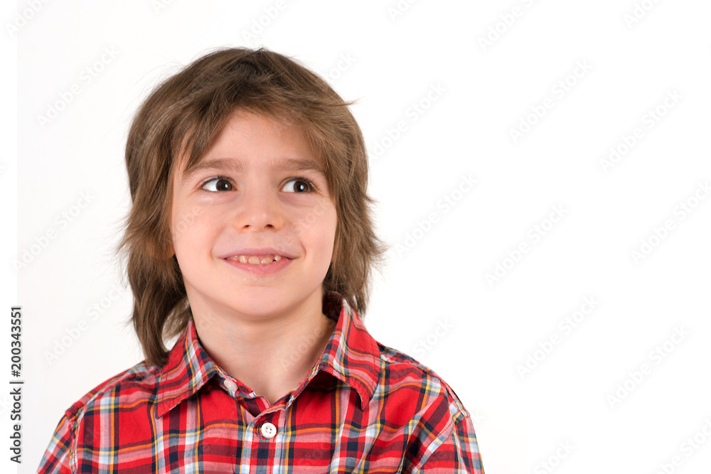 Close up emotional portrait of the smiling of the little boy   wearing   in a red shirt in a section on a white background in studio