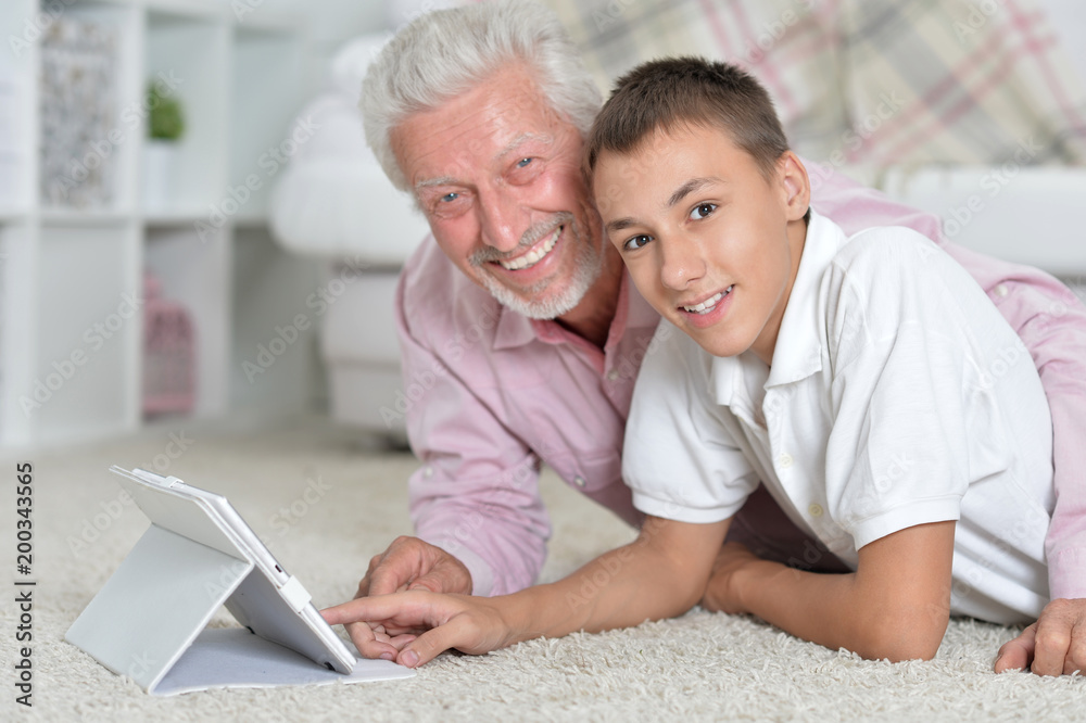 Grandfather and grandson lying on floor Grandfather and grandson lying on floor