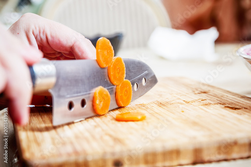 Cut carrots on wooden cutting board
