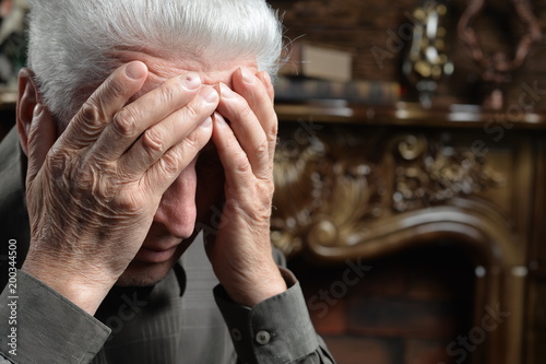 Portrait of sad senior man posing  photo