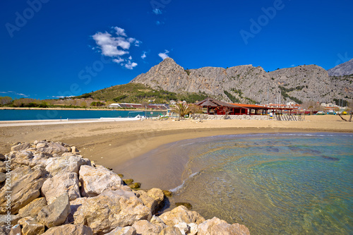 Town of Omis sand beach and Biokovo mountain coastline view photo