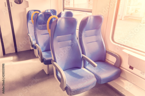 Salon of the speed commuter train with empty blue seats