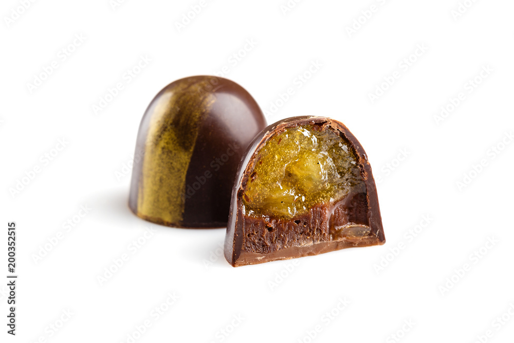 Cut luxury handmade bonbons with chocolate ganache and citrus fruit jelly filling isolated on white background Cut luxury handmade bonbons with chocolate ganache and citrus fruit jelly filling isolated on white background