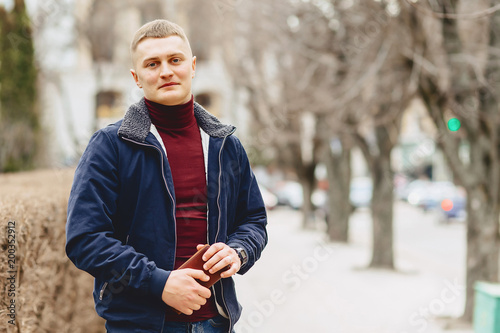 Guy in jacket stands in middle of alley
