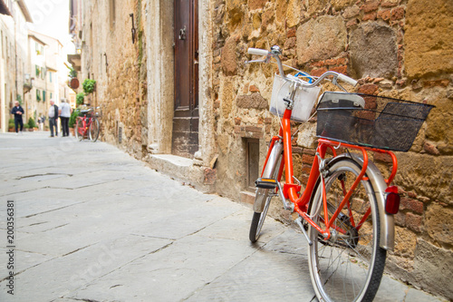 Red bicycle stop beside the wall