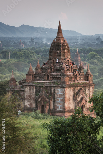 Bagan, Myanmar - October 13, 2016: Tourists watching sunrise climbed up at the ancient pagodas in Bagan, Myanmar.