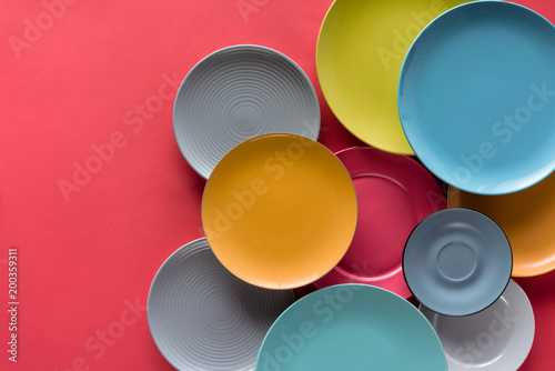 Canvas Print colorful plates composition on red background