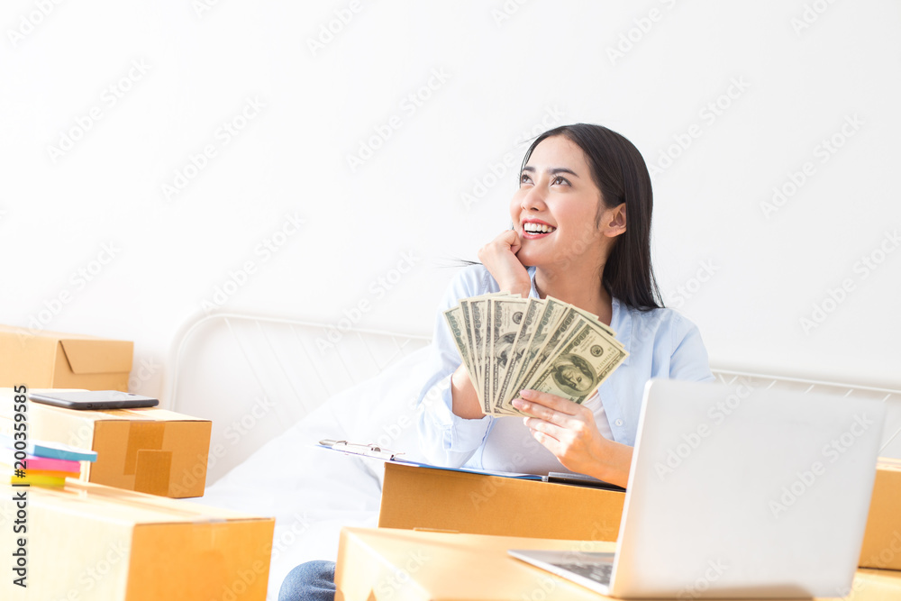 Young Asian Woman Working at home, Young Owner Woman Start up for Business Online. People with online shopping SME entrepreneur or freelance working concept. Young Asian Woman Working at home, Young Owner Woman Start up for Business Online. People with online shopping SME entrepreneur or freelance working concept.