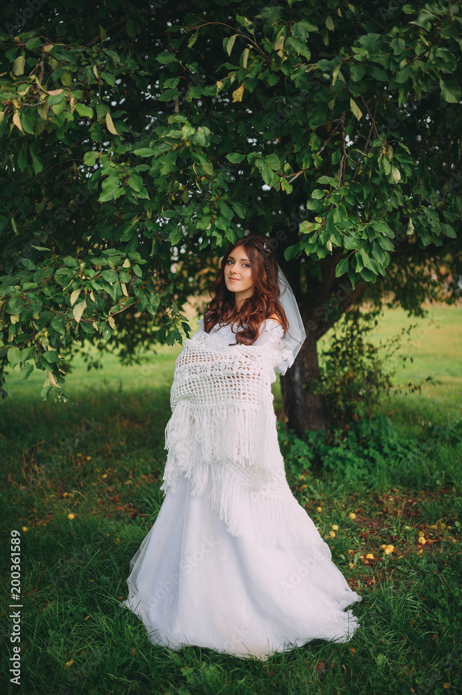 beautiful bride in a lace shawls on the nature