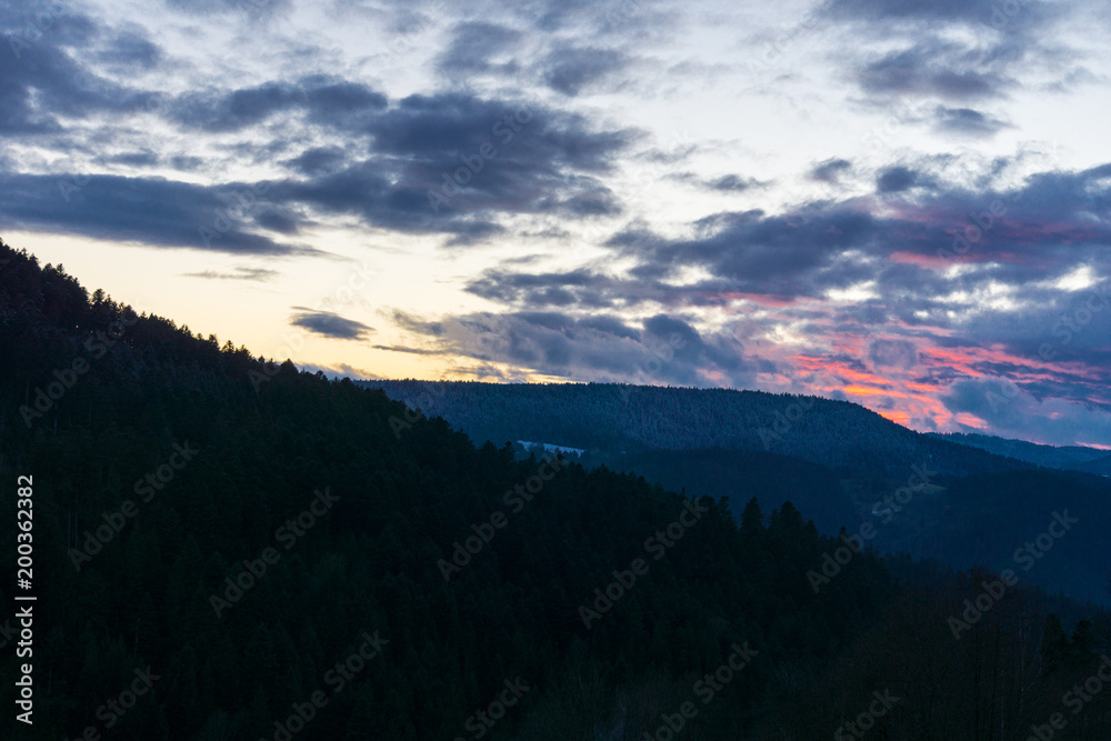 Germany, Red fire burning sunset sky in middle of black forest nature landscape
