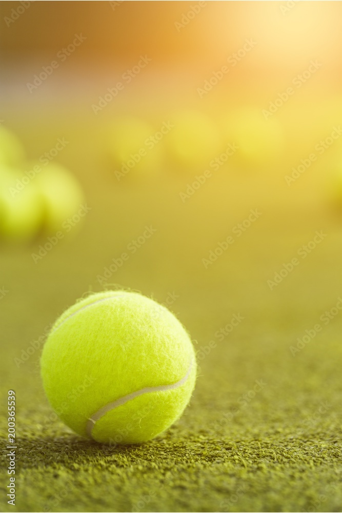 Tennis balls and rackets on grass