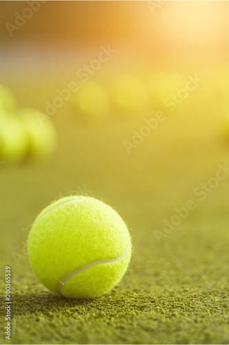Tennis balls and rackets on grass © BillionPhotos.com