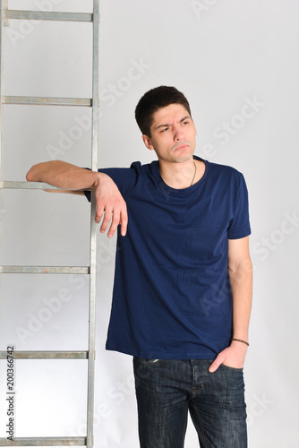 man posing near ladder. repair, design, constructor photo