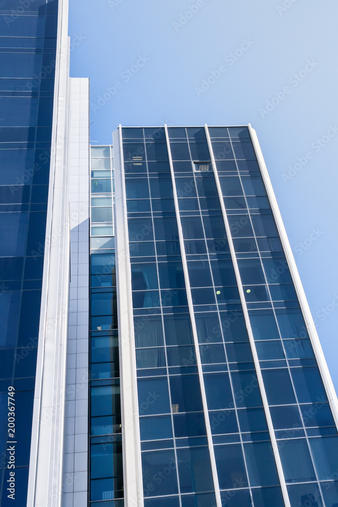 View of modern office building with blue glasses. View of modern office building with blue glasses.