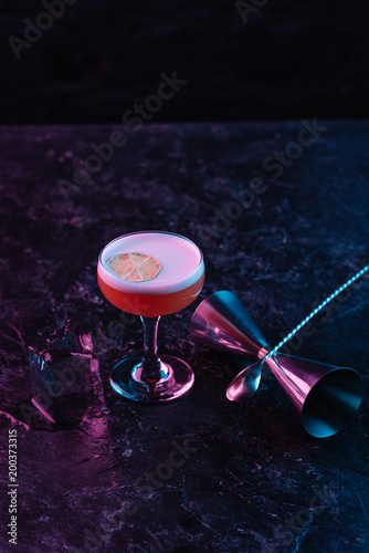 close-up view of glass with delicious conchita cocktail on dark surface photo