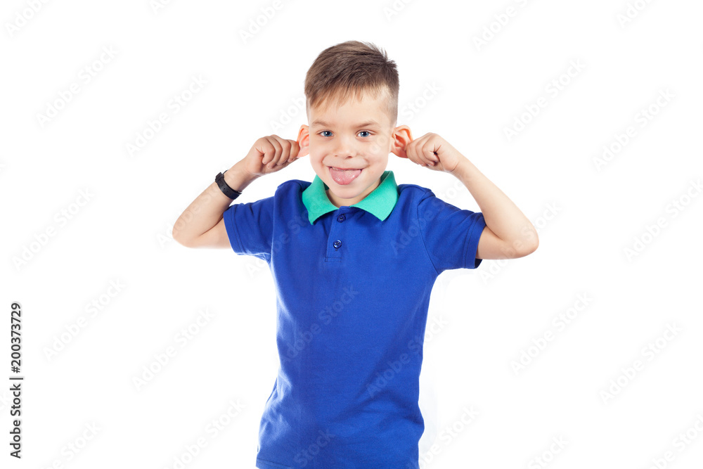 A preschool boy in a blue T-shirt is showing his tongue and making faces A preschool boy in a blue T-shirt is showing his tongue and making faces