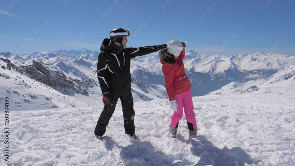 Skiers saw something interesting in the mountain valley and hand show each other Skiers saw something interesting in the mountain valley and hand show each other