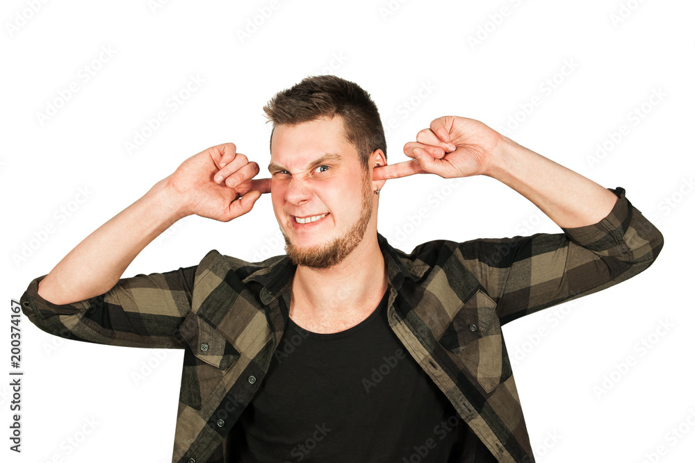 Fototapeta premium Young guy with beard and modern hairstyle mohawk, closing ears from noise, isolated on white background.