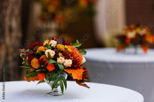 Photography autumn flower composition with roses, chrysanthemum and maple leaves