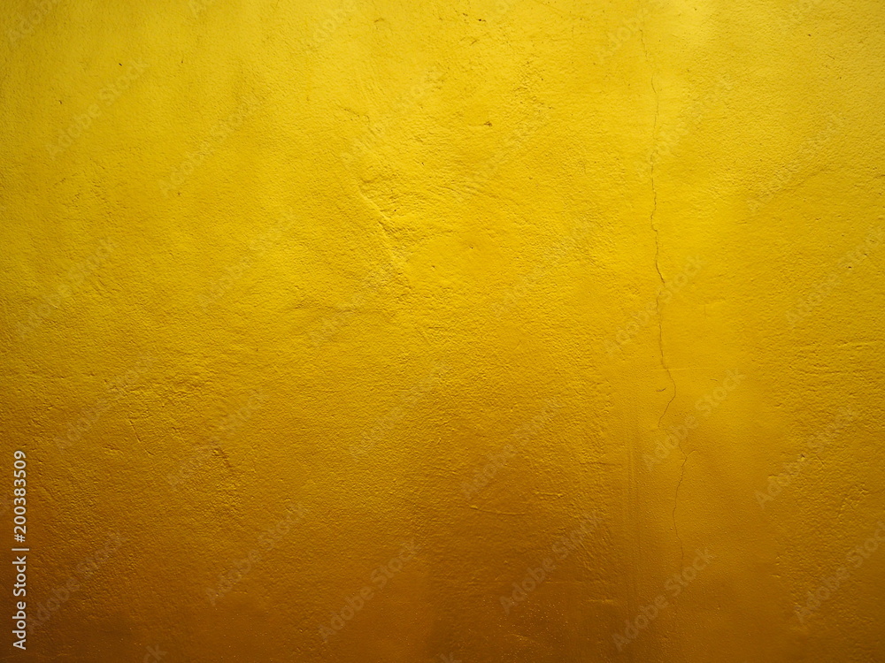 Golden wall on cement texture for background. Gold gradient. Golden wall on cement texture for background. Gold gradient.