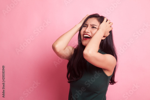 Stressed young Asian businesswoman scream out. © halfbottle