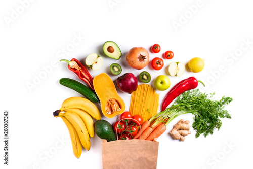 Healthy food background. Healthy food in paper bag pasta  vegetables and fruits on white. Shopping food  vegetarian concept. Top view