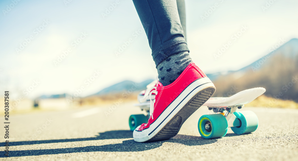 Close-up of girl's feet and penny board