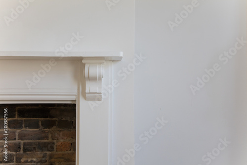 Victoriran wooden fireplace surround with white walls