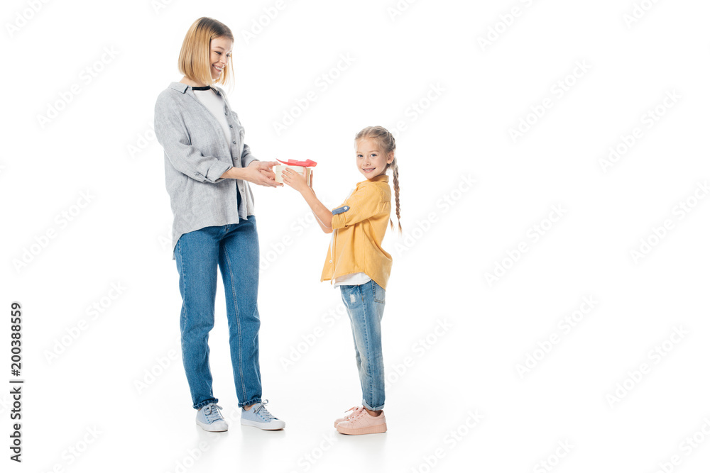 little daughter giving wrapped gift to mother isolated on white, mothers day holiday concept little daughter giving wrapped gift to mother isolated on white, mothers day holiday concept