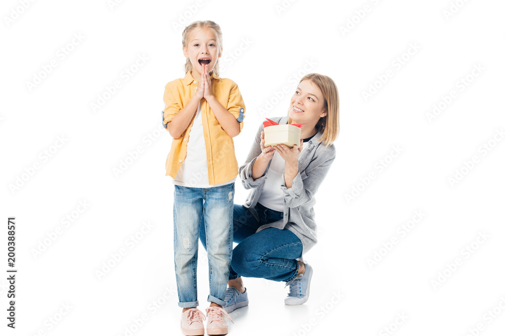 mother with wrapped gift greeting excited daughter isolated on white mother with wrapped gift greeting excited daughter isolated on white