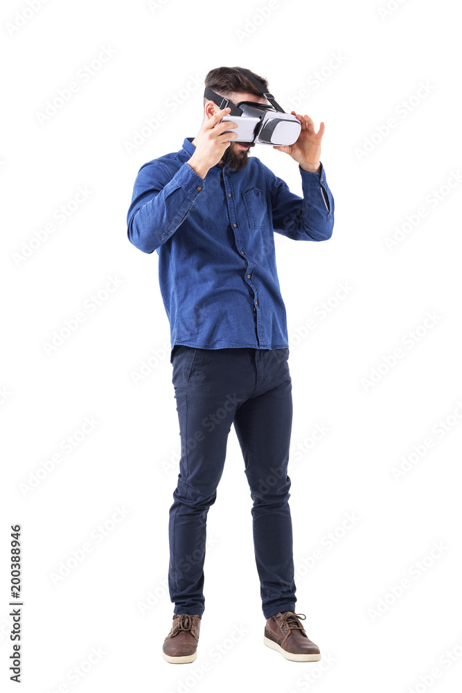 Young business man putting smart phone in virtual reality headset. Full body isolated on white background. Young business man putting smart phone in virtual reality headset. Full body isolated on white background.