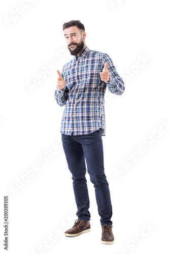Confident cool friendly bearded guy pointing finger at camera and biting lips. Full body isolated on white background. 