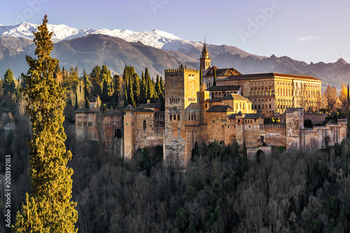 Palace and fortress complex Alhambra with Comares Tower, Palacios Nazaries and Palace of Charles V during sunset in Granada, Andalusia, Spain. photo