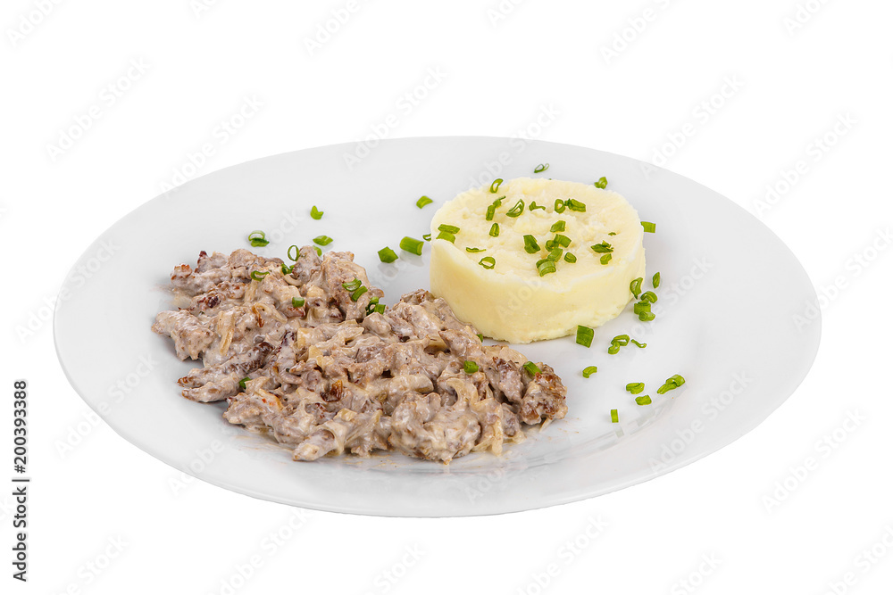 Frikasse from beef, pork, lamb meat with side dish mash potato, Green onions on a plate isolated white background. Juicy fillet, roast. For the menu bar, restaurant, cafe Side view Frikasse from beef, pork, lamb meat with side dish mash potato, Green onions on a plate isolated white background. Juicy fillet, roast. For the menu bar, restaurant, cafe Side view