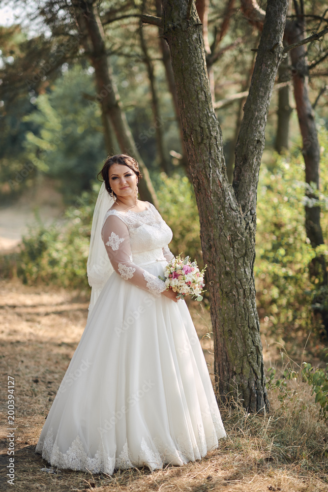 Beautiful bride outdoors in a forest.