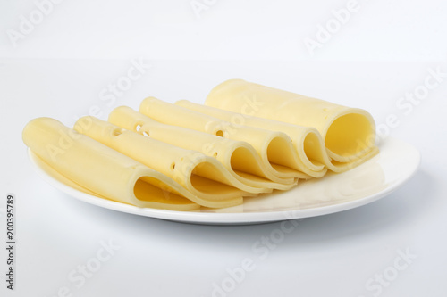 slices of cheese on a plate on a white background
