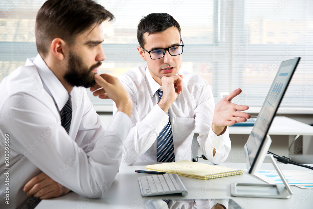 Businessmen working in an office Businessmen working in an office