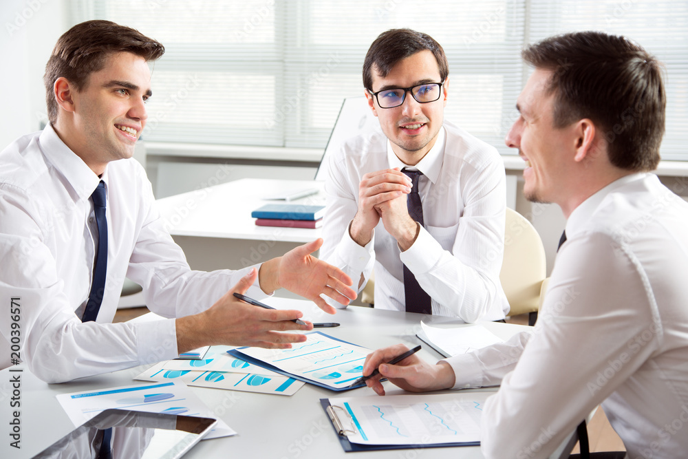 Businessmen working in an office Businessmen working in an office