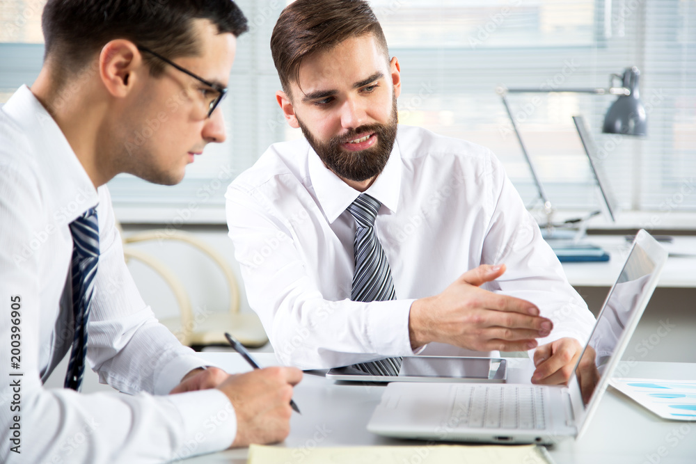 Businessmen working in an office Businessmen working in an office