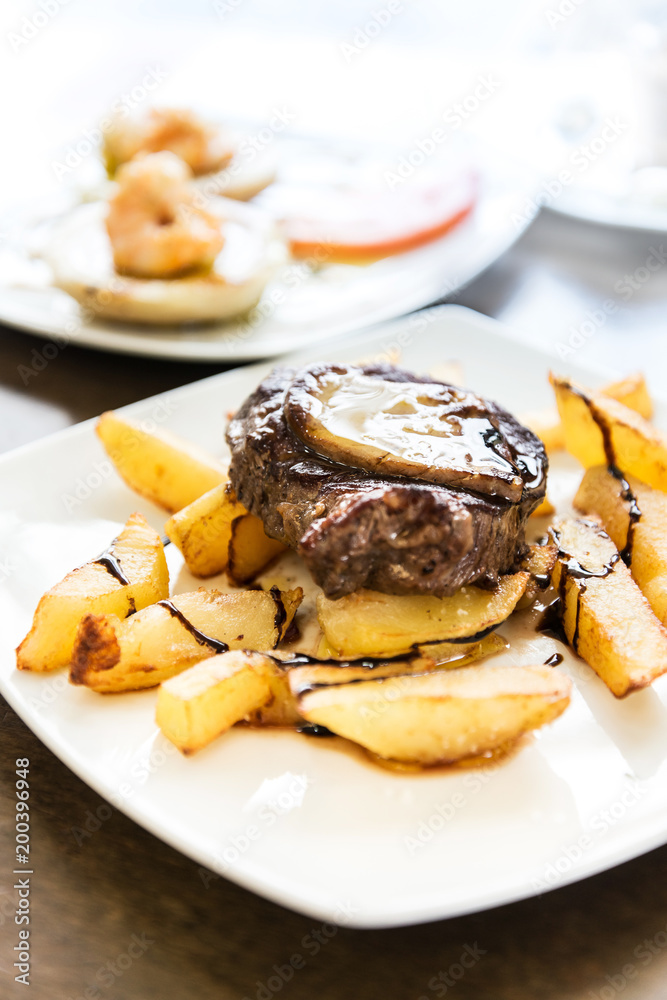 juicy steak beef meat with tomato and french fries